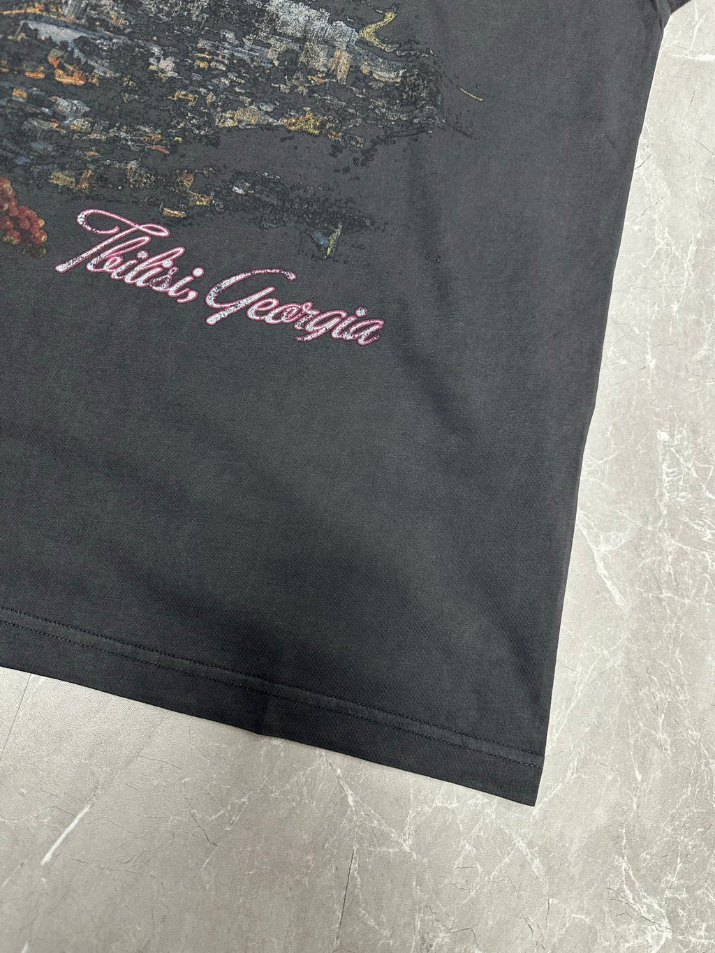 Dark charcoal T-shirt with 'Tbilisi, Georgia' graphic near bottom hem
