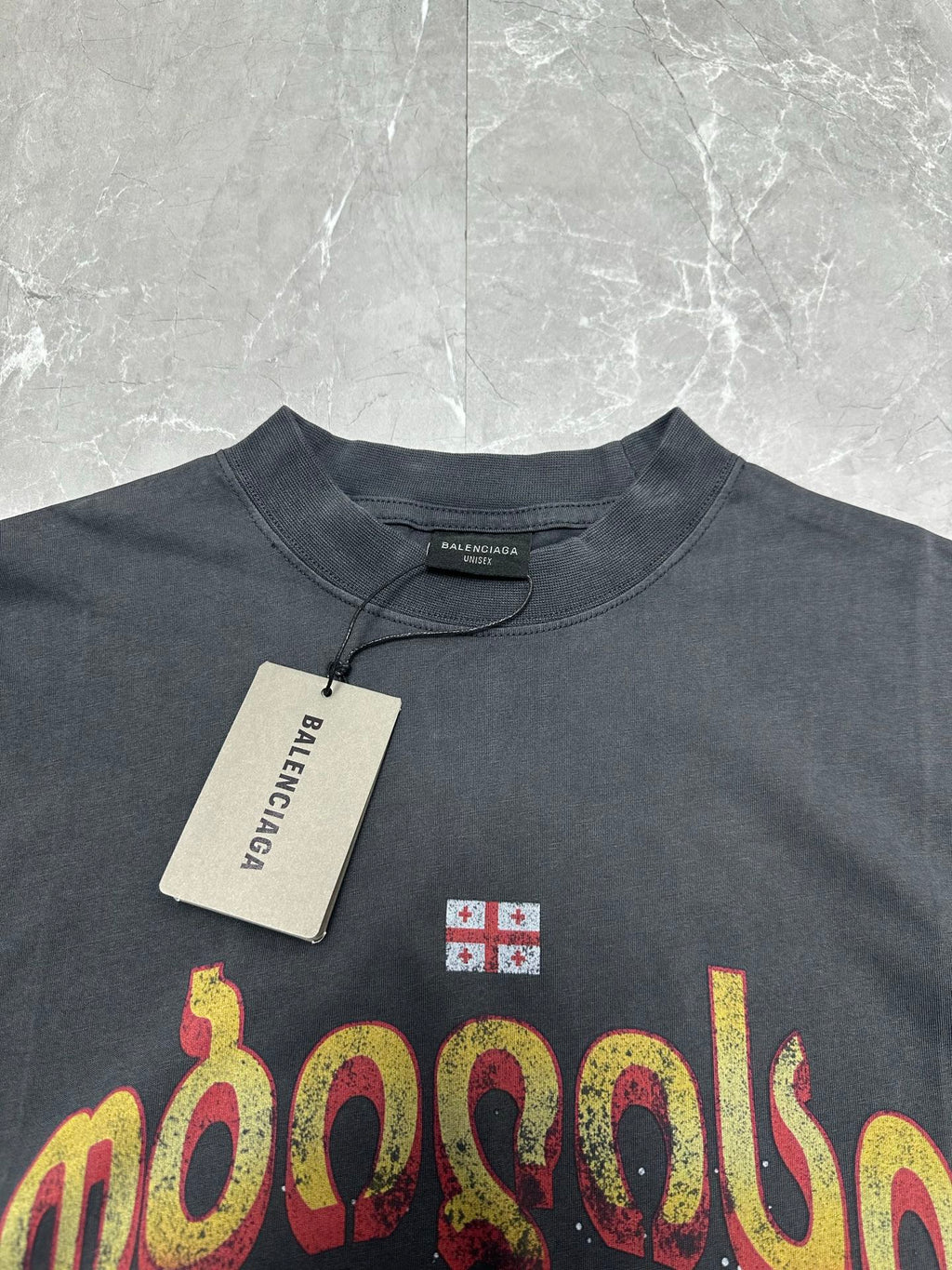 Dark charcoal graphic T-shirt neckline and front print with hanging price tag