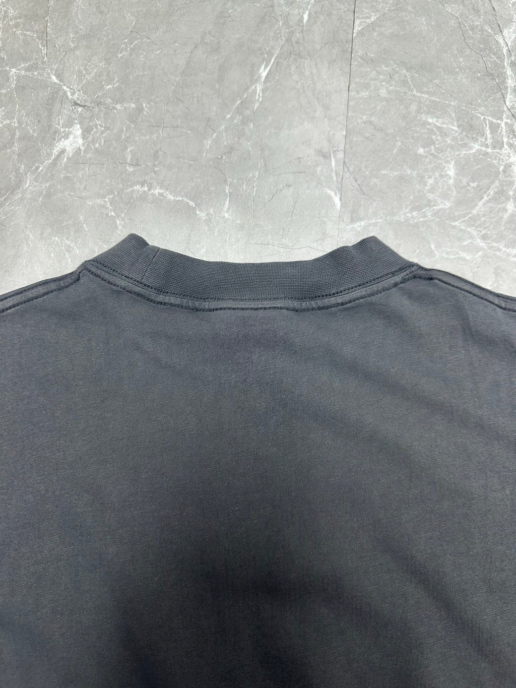 Dark charcoal T-shirt back view with crew neck and clean shoulder seam
