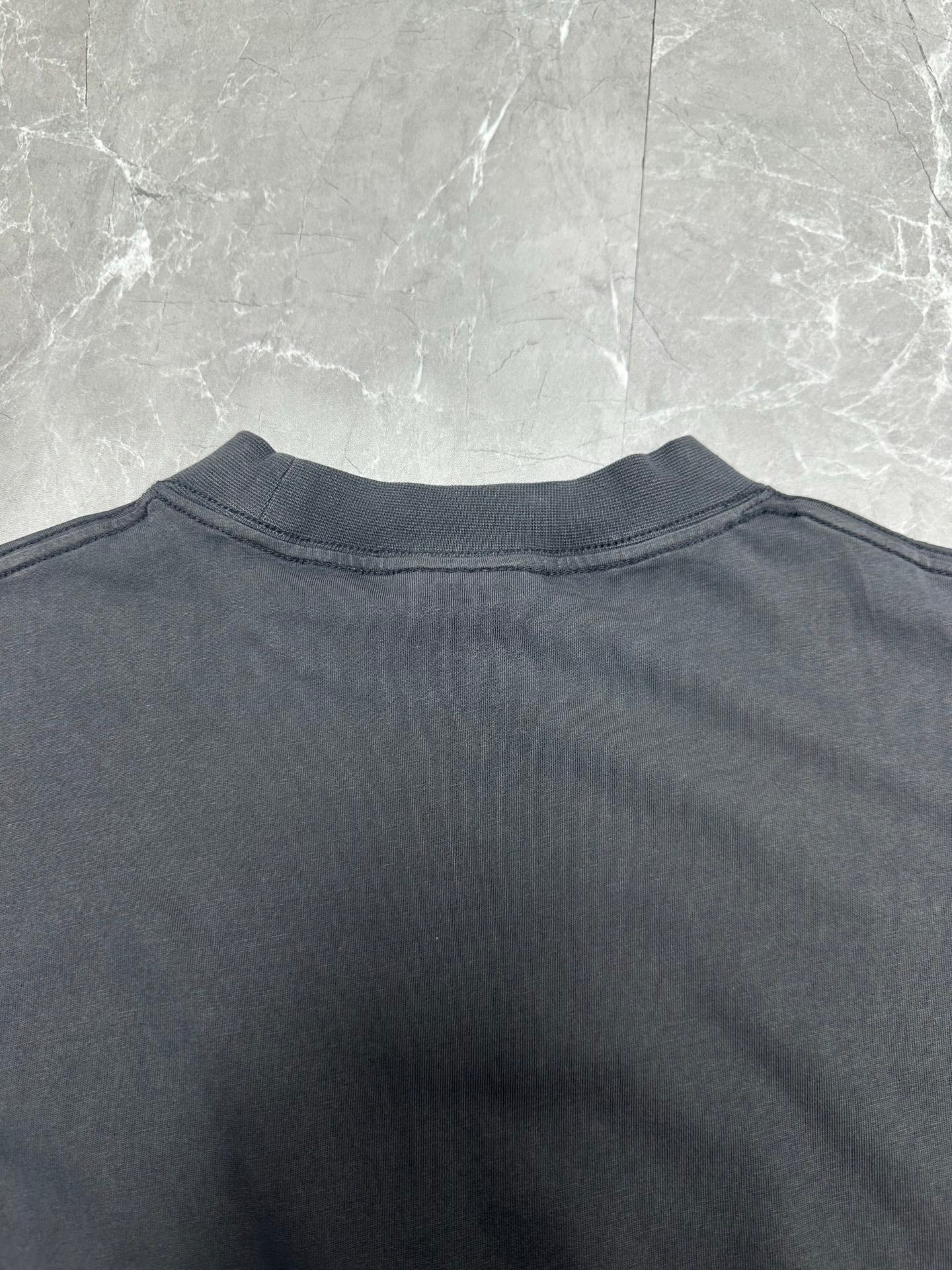 Dark charcoal T-shirt back view with crew neck and clean shoulder seam