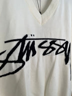 White sleeveless knit vest front with large black Stussy graphic print
