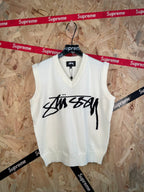 White sleeveless knit vest with V-neck and black Stussy logo graphic on front
