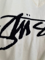 White sleeveless knit vest with oversized black Stussy lettering graphic detail