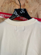 White sleeveless knit vest with crew-to-V neckline and front pull tab detail
