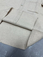 Light beige polo shirt front placket and chest pocket, button details