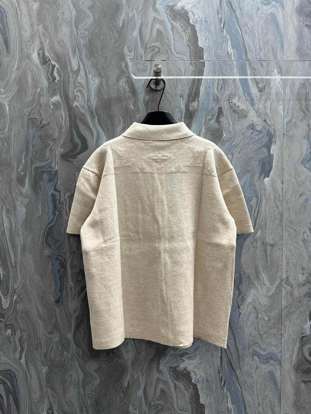 Short-sleeve polo shirt, light beige knit, back view with pointed collar