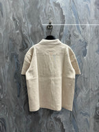 Short-sleeve polo shirt, light beige knit, back view with pointed collar