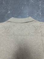 Light beige polo shirt back view, ribbed collar and smooth knit texture
