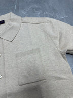Light beige polo shirt fabric detail, ribbed pocket panel and button placket