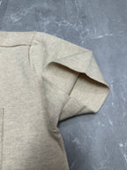 Light beige polo shirt sleeve cuff detail, textured knit and folded edge