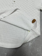 Louis Vuitton white polo shirt folded with collar, sleeve, and textured checker knit