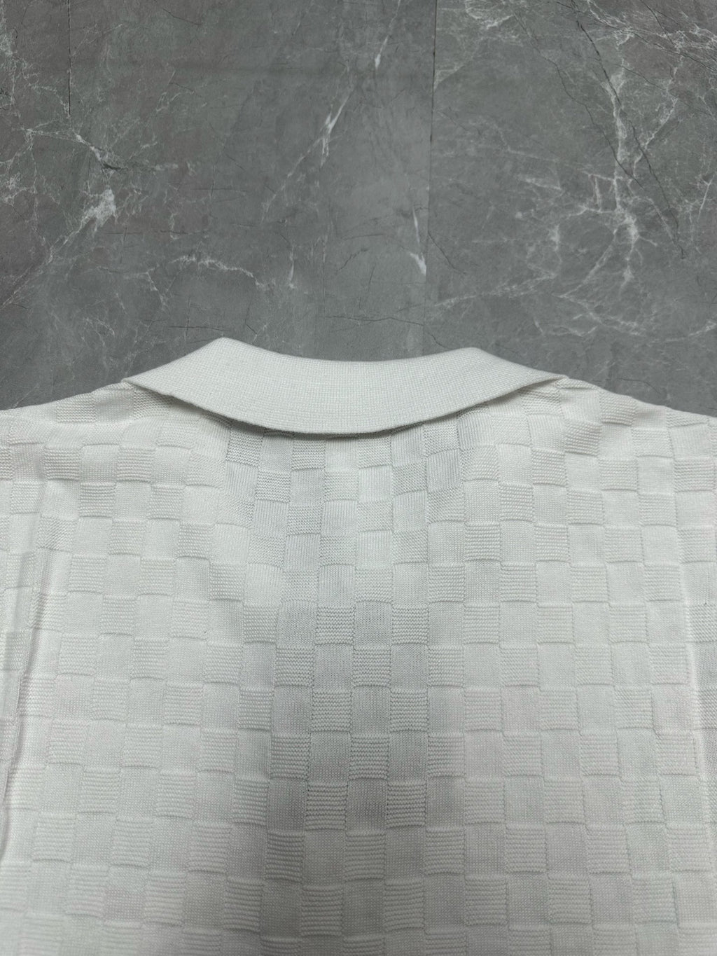 Louis Vuitton white polo shirt back view with raised collar and textured check pattern