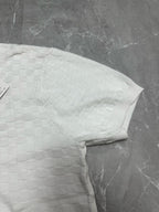Louis Vuitton white polo shirt folded side profile with textured checker knit