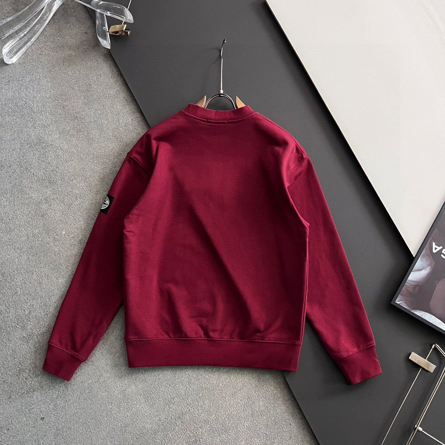 Stone Island crewneck sweatshirt, maroon, back view on hanger