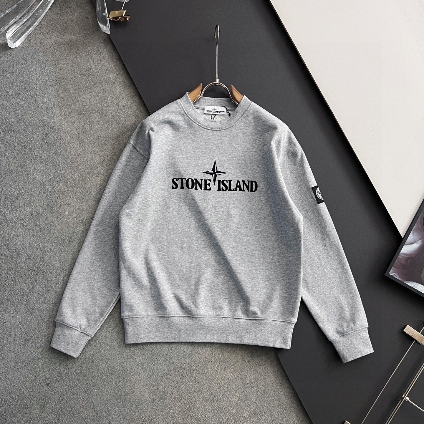 Grey crewneck sweatshirt with Stone Island chest logo and long sleeves