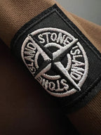 Embroidered Stone Island logo patch on dark sleeve cuff