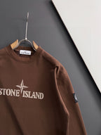Brown crewneck sweatshirt with logo print and side sleeve patch