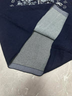 Louis Vuitton navy T-shirt folded close-up with black-and-white striped inner collar