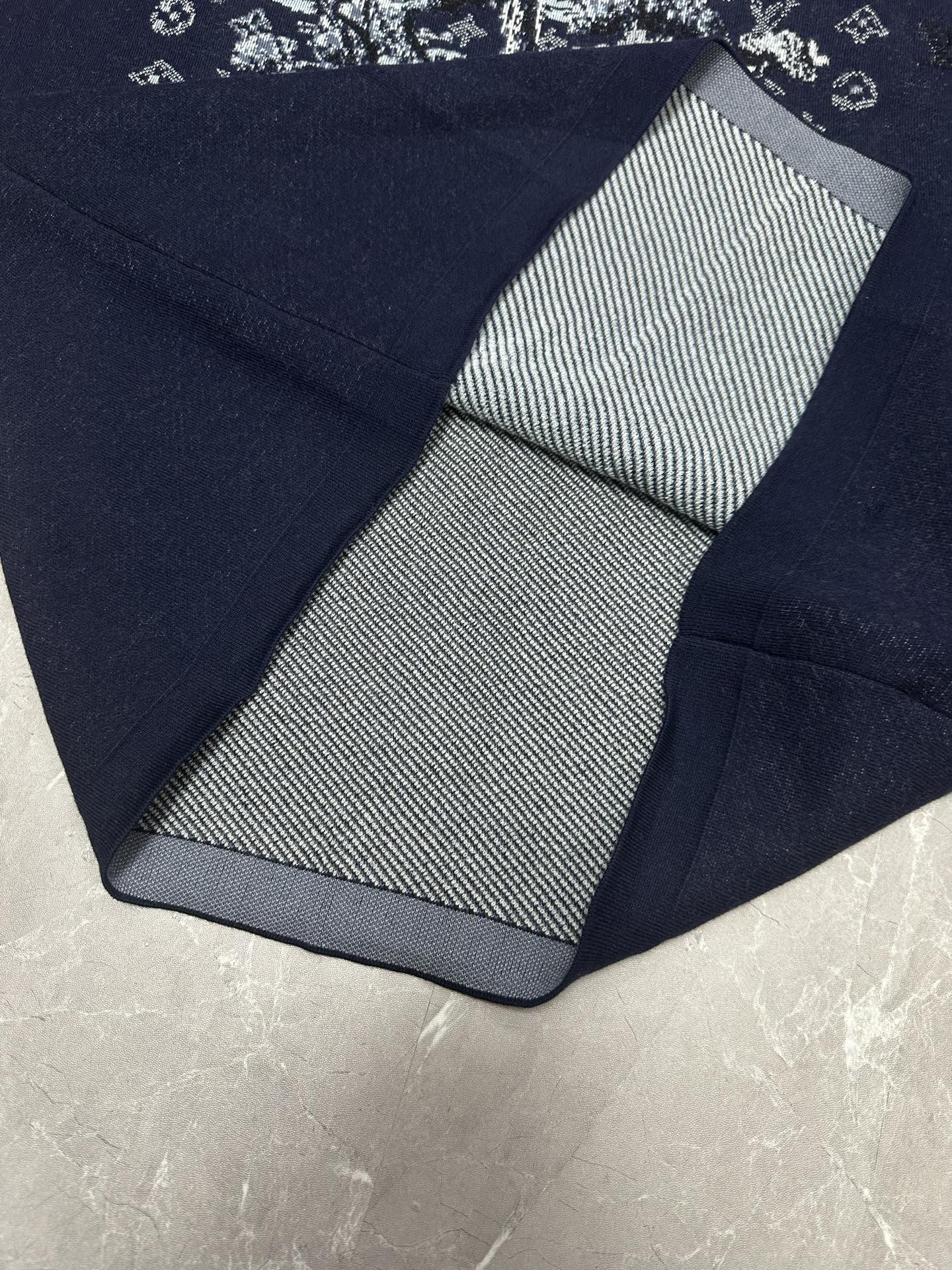Louis Vuitton navy T-shirt folded close-up with black-and-white striped inner collar