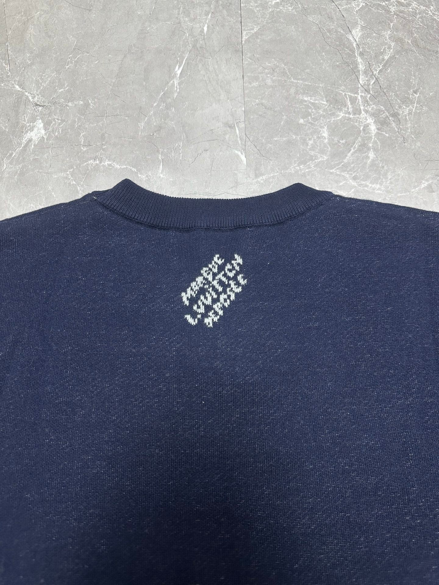 Louis Vuitton navy T-shirt back neck close-up with small white logo graphic