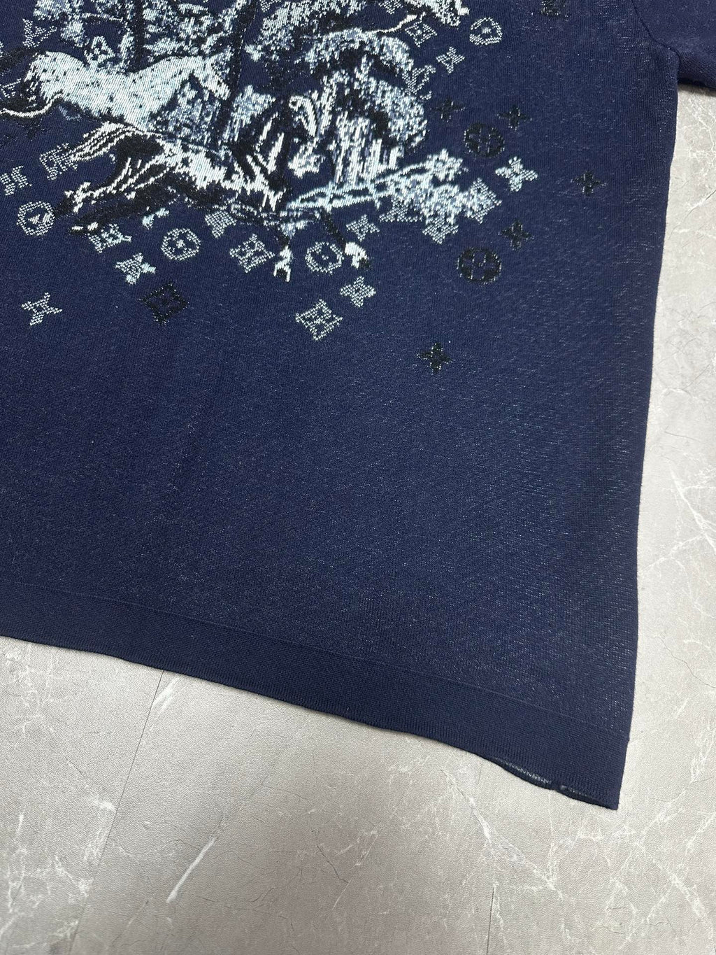 Louis Vuitton navy T-shirt close-up of white graphic print near lower front