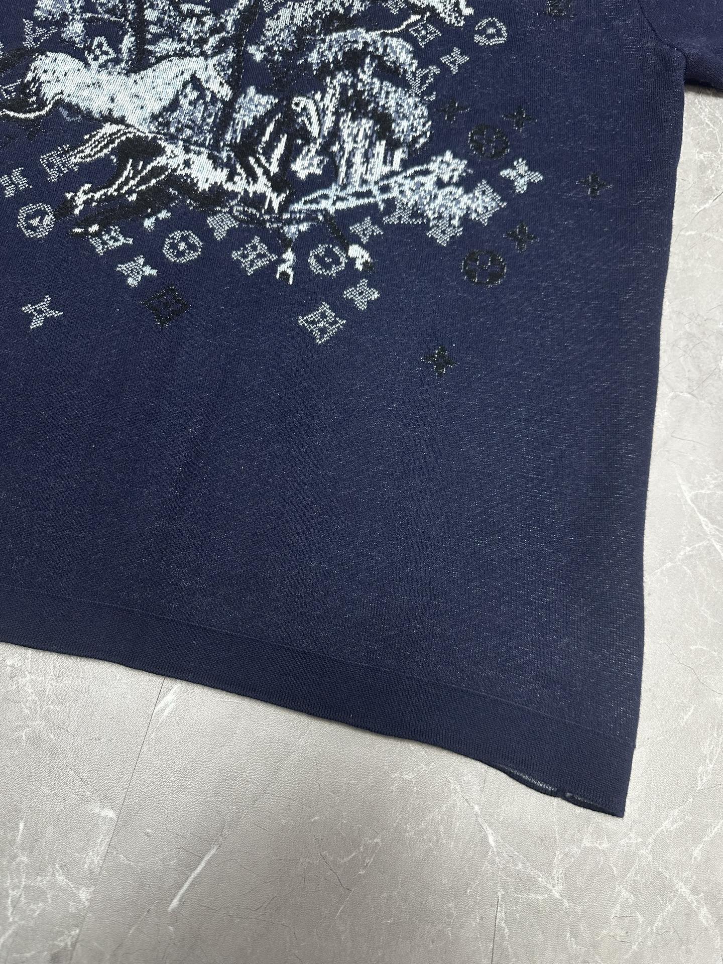 Louis Vuitton navy T-shirt close-up of white graphic print near lower front
