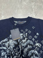Louis Vuitton navy T-shirt close-up with white crest graphic and hanging gray tag