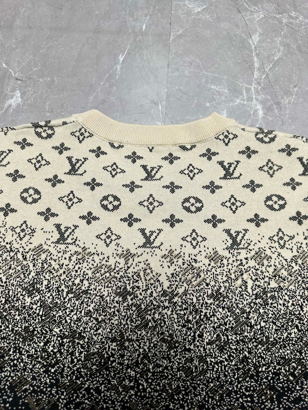 Crewneck sweater front with beige monogram print and dark speckled gradient