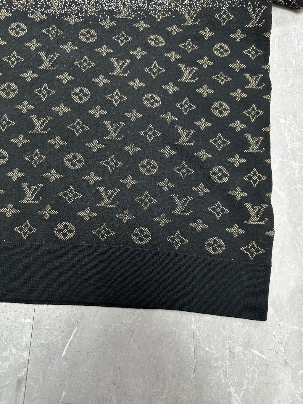 Lower front panel of monogram sweater in dark navy with scattered beige symbols