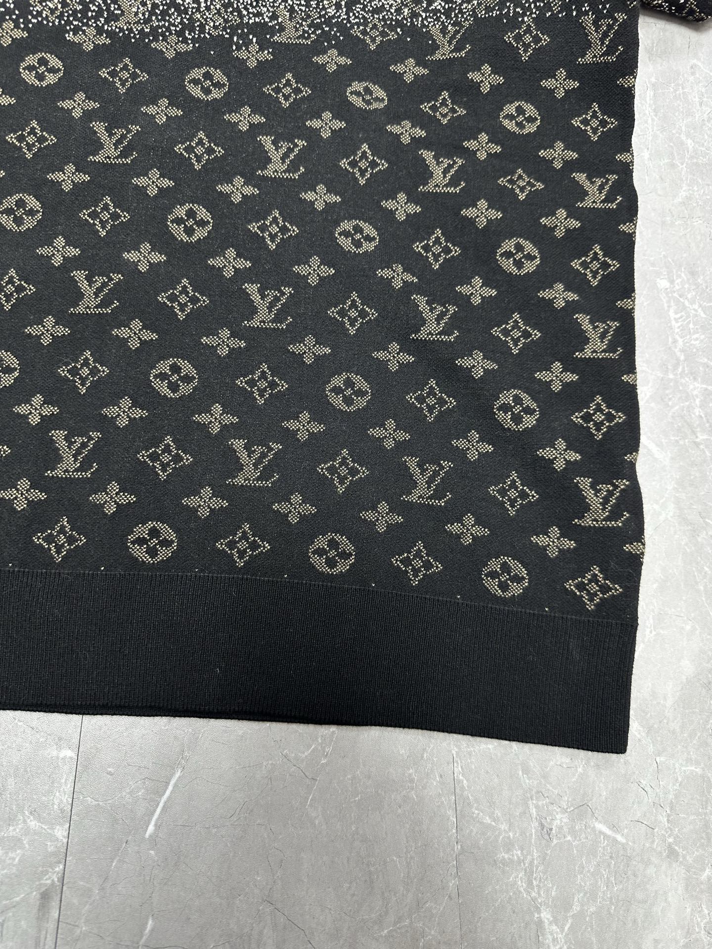 Lower front panel of monogram sweater in dark navy with scattered beige symbols