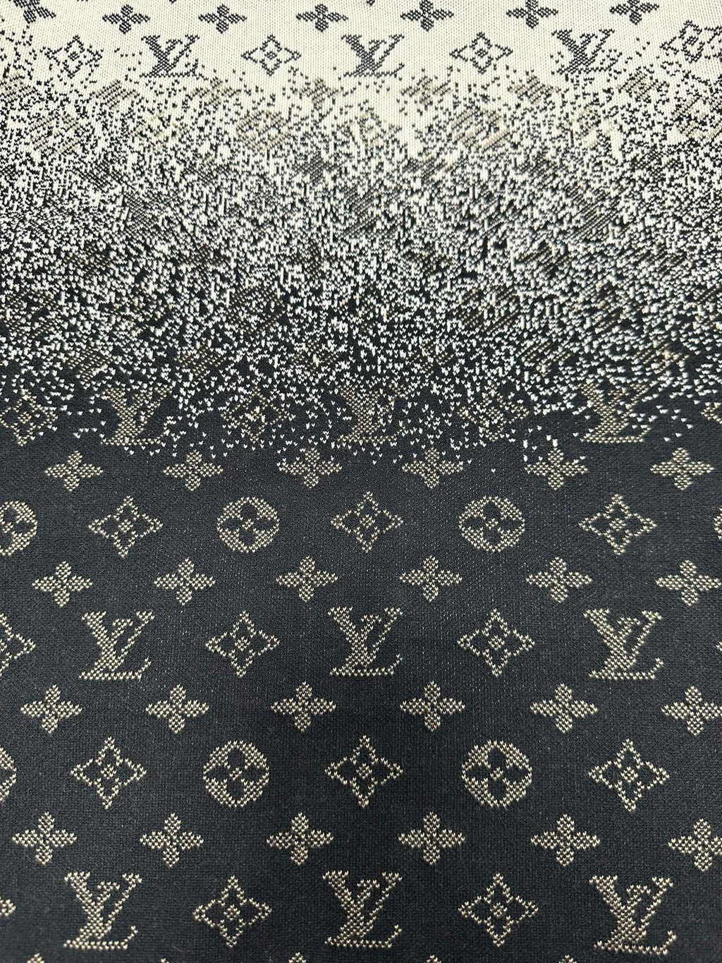 Close-up knit fabric with LV-style monogram pattern in dark navy and beige