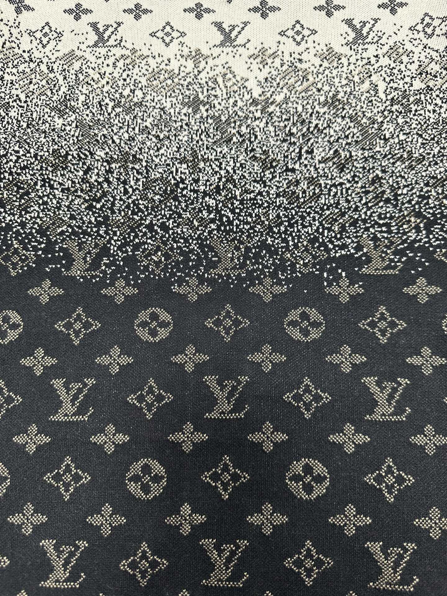 Close-up knit fabric with LV-style monogram pattern in dark navy and beige