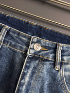 Blue denim pants with woven patch label and detailed topstitching on pocket
