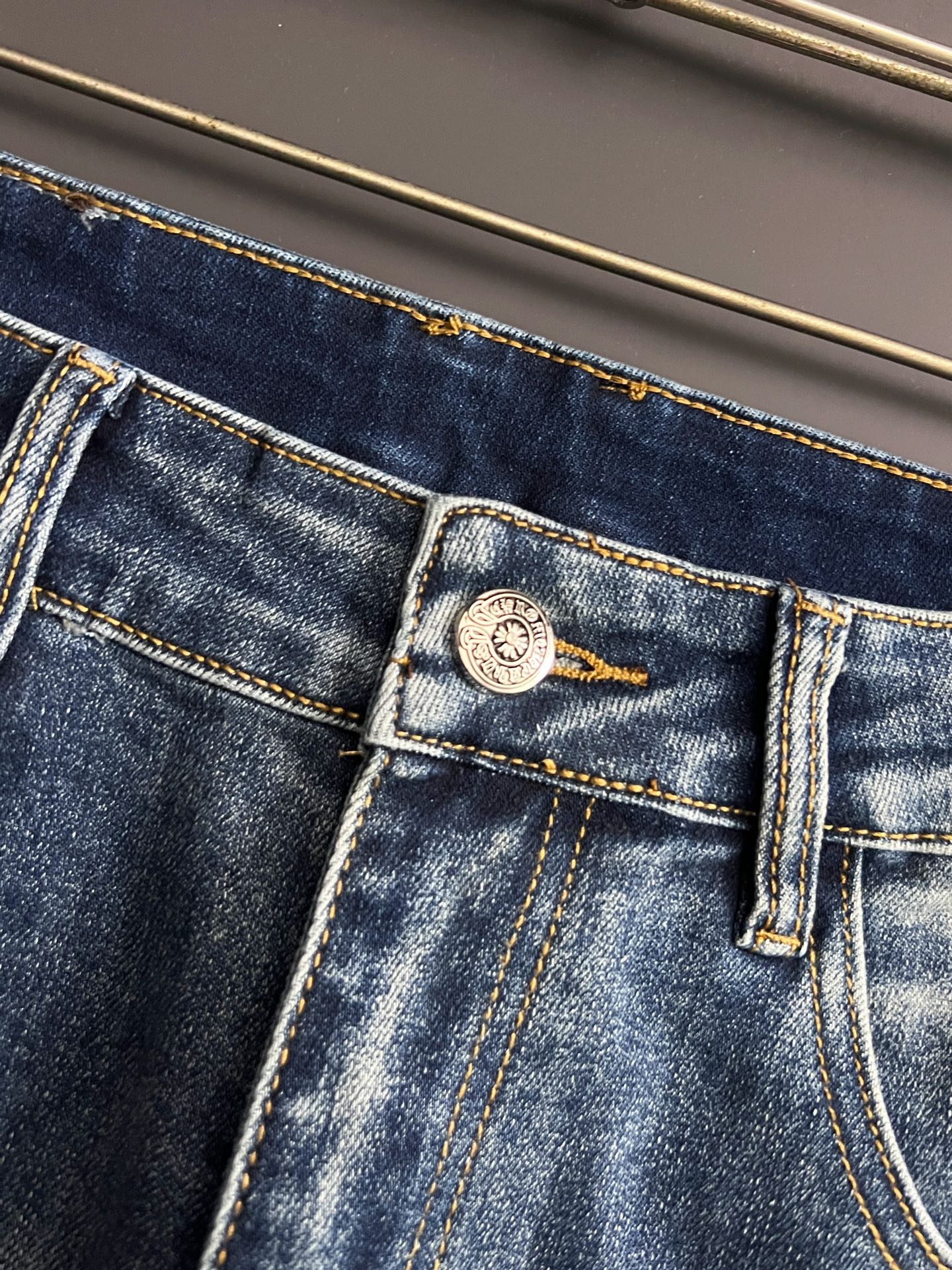 Blue denim pants with woven patch label and detailed topstitching on pocket