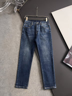 Blue denim pants with belt loops, button fly, and straight leg