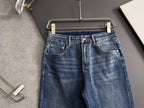 Blue denim pants with button fly and front pockets with contrast stitching