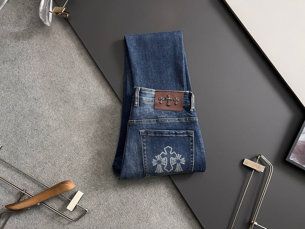 Blue denim pants with embroidered pocket patches and leather-look waistband tag