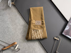 Olive Dior jeans folded on hanger, logo pocket patches shown