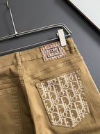 Olive Dior jeans close-up, front logo pocket patch and waistband button