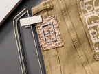 Olive Dior jeans close-up, waistband label and decorative logo patch