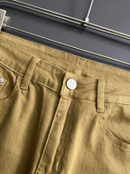 Olive Dior jeans close-up, front pocket with button and belt loops