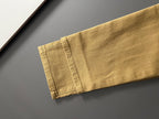 Olive Dior jeans hem close-up with stitched cuff