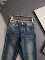 Blue denim jeans on hanger, back view with straight leg