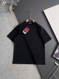 Black Gucci short-sleeve top on hanger with small front buttons and subtle print