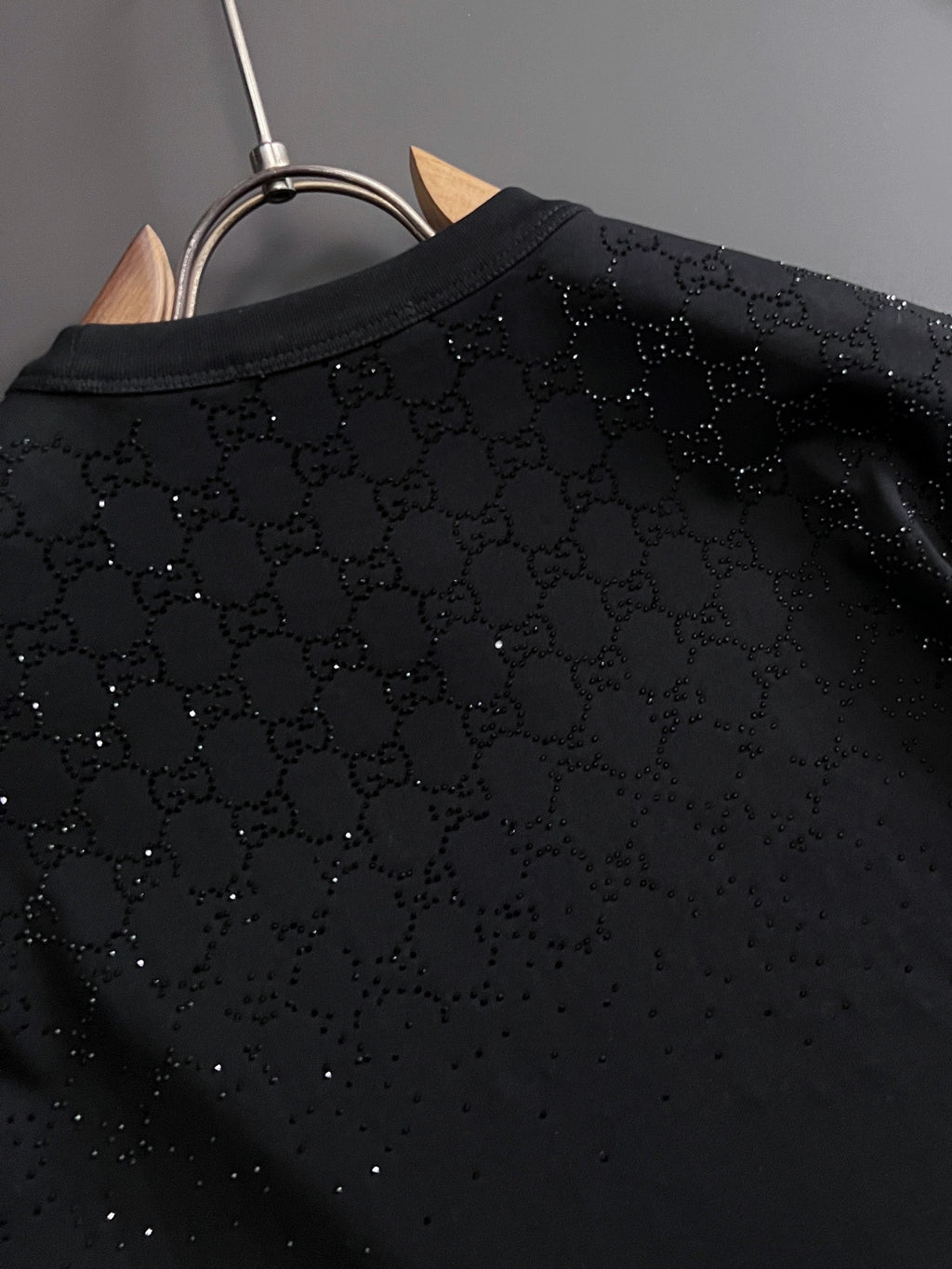 Black Gucci top back panel close-up with textured allover dotted pattern