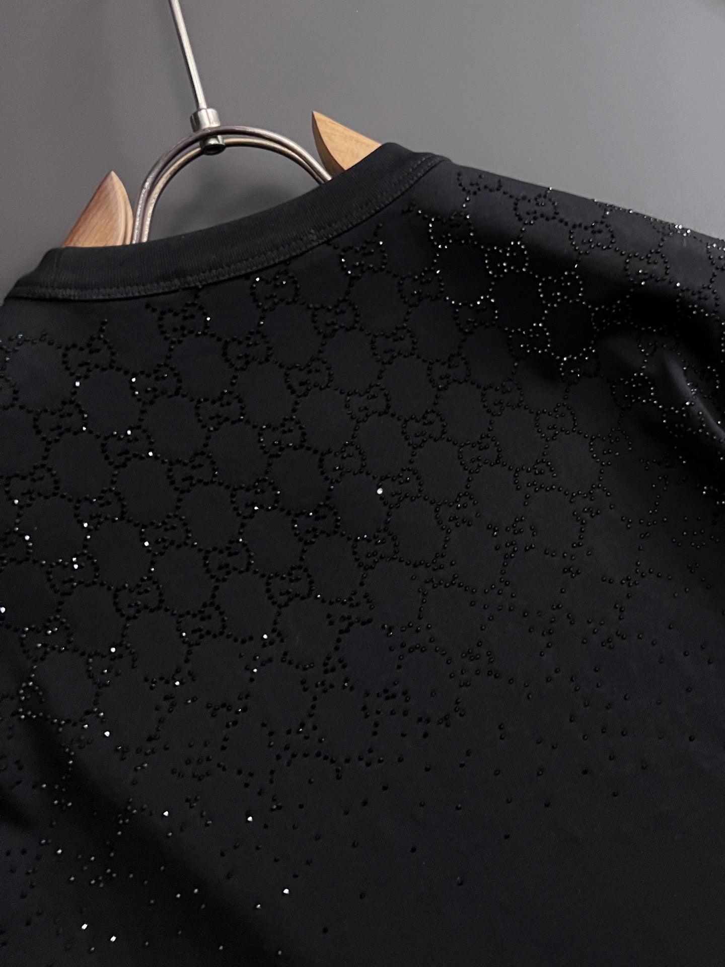 Black Gucci top back panel close-up with textured allover dotted pattern