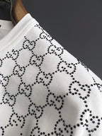 Gucci T-shirt sleeve with white knit and black studded motif pattern