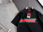 Black short-sleeve T-shirt on hanger with multicolor stripe and green Puma graphic