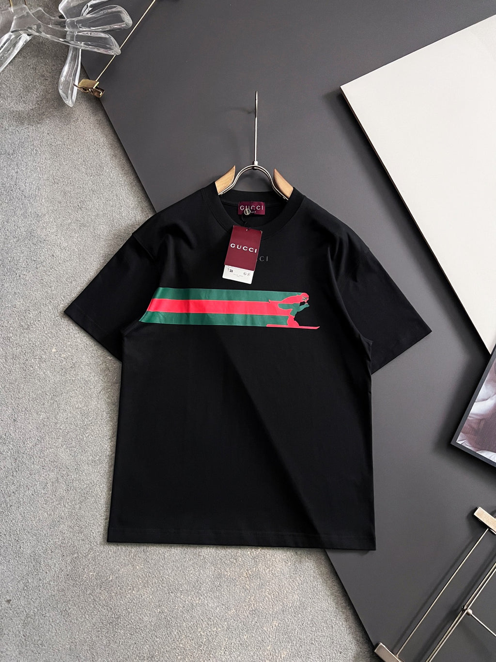 Black short-sleeve T-shirt with multicolor stripe and green Puma graphic