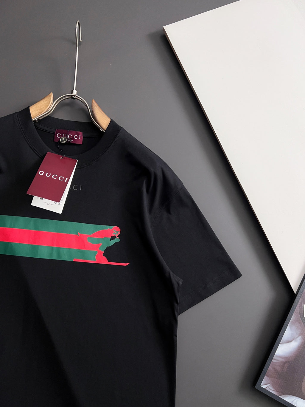 Black short-sleeve T-shirt with multicolor stripe and green Puma graphic